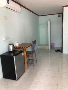 a kitchen with a table and a table and a chair at Nicha Resort Koh Phangan in Thong Sala +38 photos