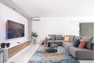 a living room with a couch and a table at Villa Skyora in Trogir