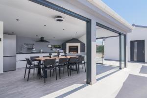 a kitchen and dining room with a table and chairs at Villa Skyora in Trogir
