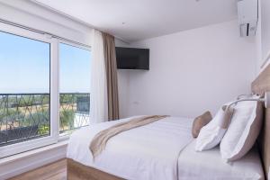 a bedroom with a bed and a large window at Villa Skyora in Trogir +74 photos