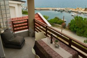 a balcony with a table and a view of a harbor at Porto Athos apartments 1345 in Nea Roda