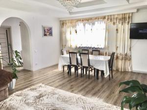 a dining room with a table and chairs at Дом в Боровом in Borovoye