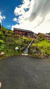 a train on a hill with stairs next to a building at Chalet Le Salers 10pers Le Mont Dore in Mont-Dore +45 photos