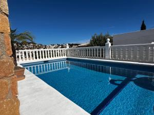 a swimming pool next to a white fence at Villa Studio44 a Luxury villa in Benissa Costa, max 8 guests, great pool, 700 m2 in Benissa