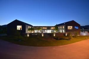 a house at night with its lights on at Q.C.M. Campus in Belp