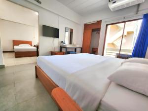 Postel nebo postele na pokoji v ubytování Siam Palace Hotel
