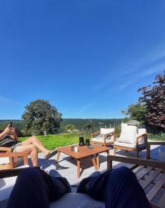 a couple of people sitting on a patio at Nature Circuit Francorchamps in Stavelot