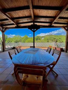 a blue table and chairs on a patio at Maravillosa villa con piscina y barbacoa in Puigventos