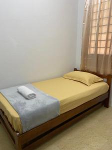 a bed sitting in a room with a window at De'Garden 12 in Alor Setar +1 photo