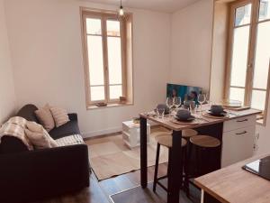 a living room with a table with wine glasses on it at Urban Nest - Hypercentre in Clermont-Ferrand