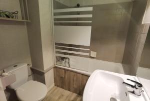 a bathroom with a white sink and a toilet at MyHome - Génépis 29 - 4pax skis aux pieds Val Claret in Tignes +5 photos
