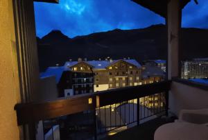 a view of a city from a balcony at night at MyHome - Génépis 29 - 4pax skis aux pieds Val Claret in Tignes