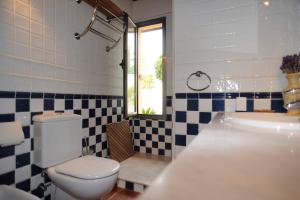 a bathroom with a toilet and a tub and a sink at Casa Tagoro, facing the Ocean in Tacoronte +30 photos