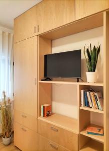 a large wooden cabinet with a tv in it at CADEMU Camaga in LʼAquila