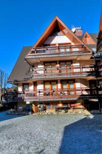 a large building with a gambrel roof at udanypobyt Apartamenty Pastelowe in Zakopane