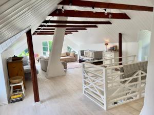 a living room with a white staircase in a house at Christiansfrid - Humlaryd in Eringsboda