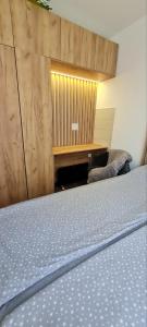 a bedroom with a bed and a wooden wall at Apartman Djurdja in Divčibare
