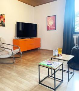 a living room with a tv and a coffee table at Urlaub in der Eifel direkt am Rursee - Seewinkel in Simmerath