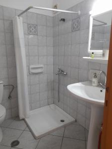a bathroom with a shower and a sink at Pagonis Studios in Lixouri +23 photos