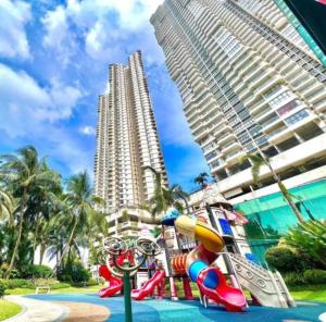 a playground in front of some tall buildings at Bay Point Love Bed Danga Bay in Johor Bahru