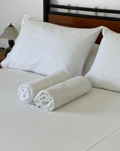 a pair of towels sitting on top of a bed at Pagonis Studios in Lixouri