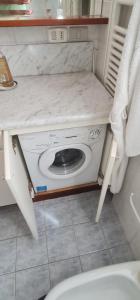 a bathroom with a white counter top with a toilet at Appartamento per relax in Rimini
