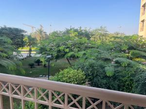 a view of a park from a balcony at Property Sisters Madinaty, Elite garden view B2 in Madinaty