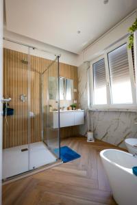 a bathroom with a shower and a tub and a sink at VibeS in Centro apartment & rooms in Pagani