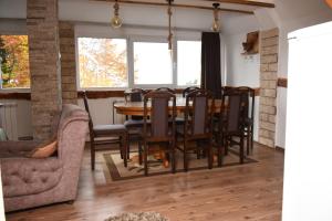 a dining room with a table and chairs at Vikendica Čeperković #1 in Kopaonik