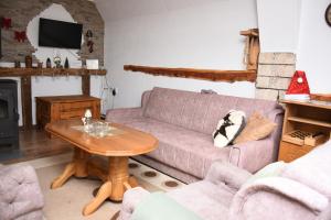 a living room with a couch and a table at Vikendica Čeperković #1 in Kopaonik
