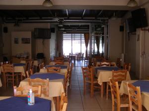 a dining room with tables and chairs with blue table cloth at ΙΩΑΝΝΑ in Dhirrévmata +4 photos