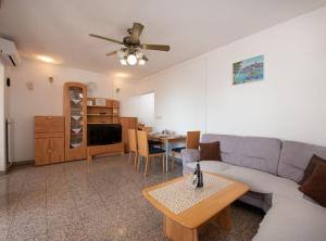 a living room with a couch and a table at Cozy Icici Apartment with Sea view in Ičići