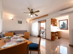 a living room and dining room with a table and chairs at Cozy Icici Apartment with Sea view in Ičići +6 photos