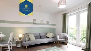 a living room with a couch and a window at large 2 bed central apartment with balcony and private parking in Cardiff