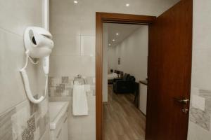 a white bathroom with a phone on the wall at Old Stone Boutique Hotel in Lefkosa Turk +82 photos