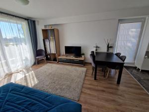 a living room with a black table and a couch at Airplane Residence 1 in Otopeni