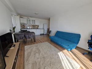 a living room with a blue couch and a table at Airplane Residence 1 in Otopeni