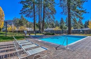 a swimming pool with two lounge chairs next to at Sky Lake Splendor condo in South Lake Tahoe
