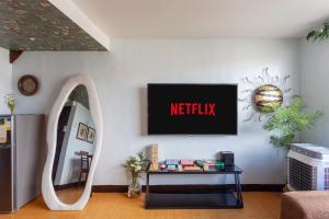 a living room with a netflix sign on the wall at Viors Staycation in Cainta +5 photos
