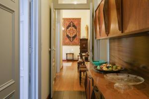 a kitchen with a counter with a bowl of fruit on it at Casa da Avó Guida in Ponta Delgada +25 photos