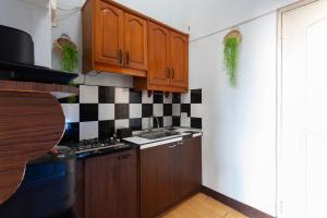 a kitchen with wooden cabinets and a sink at Viors Staycation in Cainta