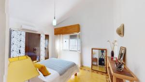 a bedroom with a bed and a desk and a mirror at Casa chalet , Centro de La Paloma in La Paloma