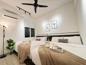 Giường trong phòng chung tại Ipoh Town Majestic Suites by IWH Suites