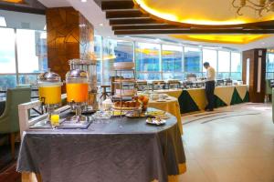 a table with food and drinks on it in a restaurant at Hotel Valley Garden - Sylhet in Sylhet
