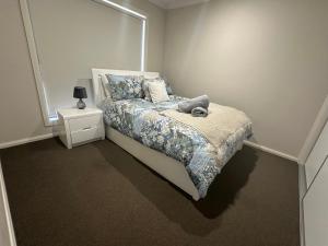 a bedroom with a bed and a window at Quiet Comfort for Relaxing Stays in Point Cook