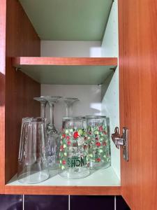 a shelf with two glass items on it at Airrose two bed apartment in Wolverhampton