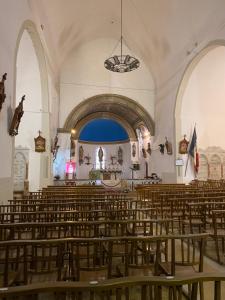 an empty church with a bunch of chairs in it at Maison Familiale Style Chalet - Centre village in Formiguères