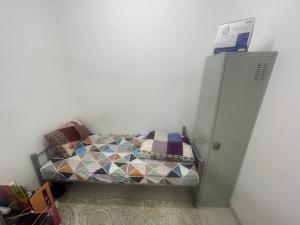 - un petit lit dans un coin de chambre dans l'établissement Shafeeq Kuri, à Ajman