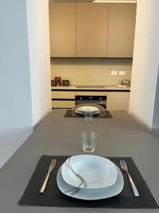 a table with a white plate and fork and knife at Monolocale centro storico in Novara