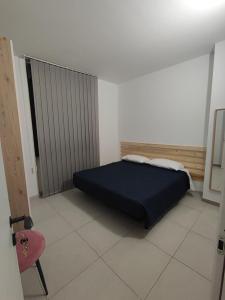 a bedroom with a bed and a red chair at La suite di Carola in Villasanta